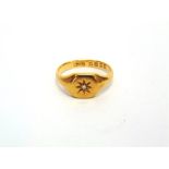 AN 18 CARAT GOLD SIGNET RING star set with an old single cut diamond, finger size O, 4.5g gross