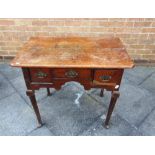 A GEORGE III PROVINCIAL OAK LOWBOY fitted with three drawers on cabriole supports, 81cm wide 50cm