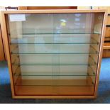 A PAIR OF BEECH COLOURED GLAZED DISPLAY CABINETS each containing six adjustable glass shelves,