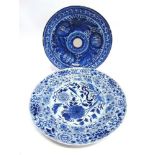 A LARGE DELFT CHARGER with underglaze blue floral painted decoration within a shaped border, 38.
