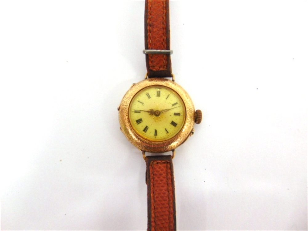 A FOB WATCH converted to a watch, stamped '14k', with a gilt metal cuvette