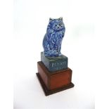 AN RSPCA CERAMIC CHARITY BOX, modelled as a seated cat on box inscribed 'PLEASE HELP THE ROYAL