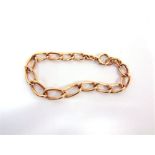 A 9 CARAT GOLD BRACELET of rose coloured long curb links, 24.5g gross