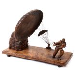 SECOND WORLD WAR - AN UNUSUAL LARGE CARVED WOODEN STYLIZED SCULPTURE OF A PARATROOPER MAKING A