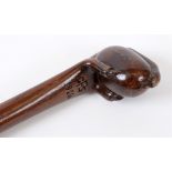 GREAT WAR - A MAHOGANY CARVED WALKING CANE with egg and claw stylized grip, tapered shaft