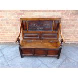 AN OAK BOX SETTLE, the panelled back bearing initials and date 'AF 1673', 101cm wide 43cm deep