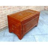 A CAMPHORWOOD BLANKET BOX with carved decoration, 104cm wide 53cm deep 61cm high