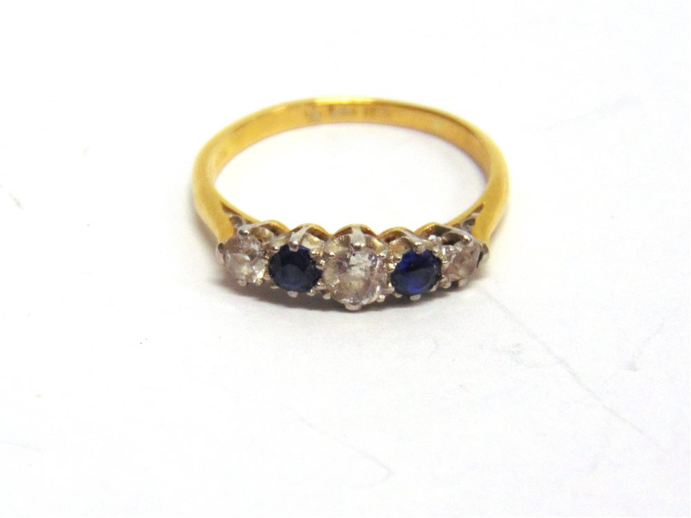 A SAPPHIRE AND DIAMOND FIVE STONE RING stamped '18ct' and 'Pt', the three graduated brilliant cut