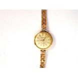 GARRARD a lady's 9 carat gold bracelet watch, presentation inscription to the case, in the