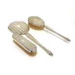 A THREE PIECE AMERICAN DRESSING TABLE SET comprising a hand mirror, hair brush and clothes brush,