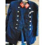 A FIREMAN'S TUNIC early 20th century, by Veasey & Son of Rugby, dark blue with red facings; together