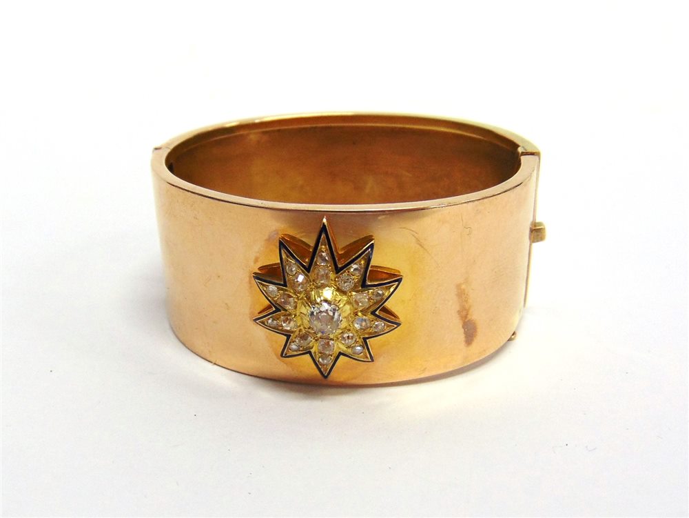 A VICTORIAN DIAMOND CLUSTER SET HINGED BANGLE the detachable starburst cluster with dark blue enamel