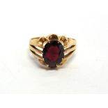 A GENTLEMAN'S 9 CARAT GOLD GARNET SET RING finger size U 1/2, 4.5 gross