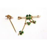 AN ENAMEL AND PEARL SET FOUR LEAF CLOVER BAR BROOCH with three similar three leaf clovers