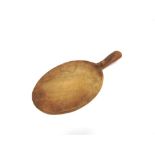A ROBERT 'MOUSEMAN' THOMPSON CARVED AND ADZED OAK CHEESE BOARD of oval form, the handle with