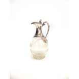 A VICTORIAN SILVER MOUNTED GLASS CLARET JUG by William & George Sissons, Sheffield 1864, the bulbous