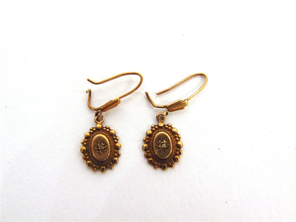 A PAIR OF VICTORIAN STYLE DROP EARRINGS the oval panels star set with a simple cut diamond