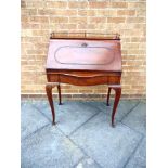 AN EDWARDIAN MAHOGANY BUREAU DE DAME with brass gallery and fitted interior, shaped drawer and