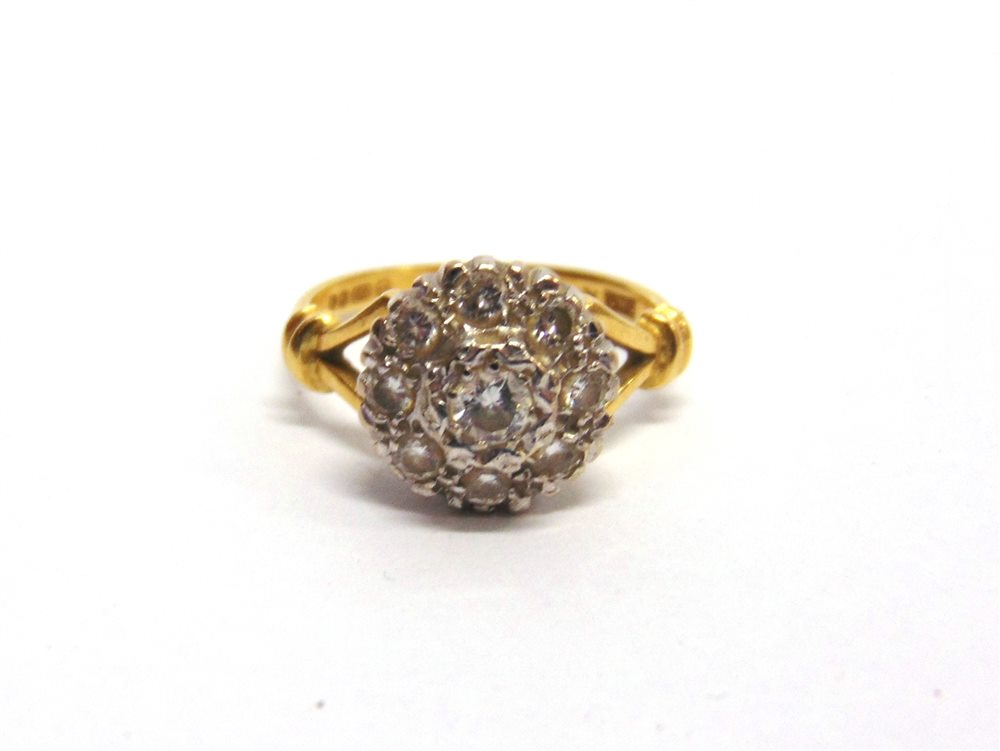 A NINE STONE DIAMOND 18 CARAT GOLD CLUSTER RING the illusion set brilliant cuts totalling