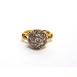 A NINE STONE DIAMOND 18 CARAT GOLD CLUSTER RING the illusion set brilliant cuts totalling
