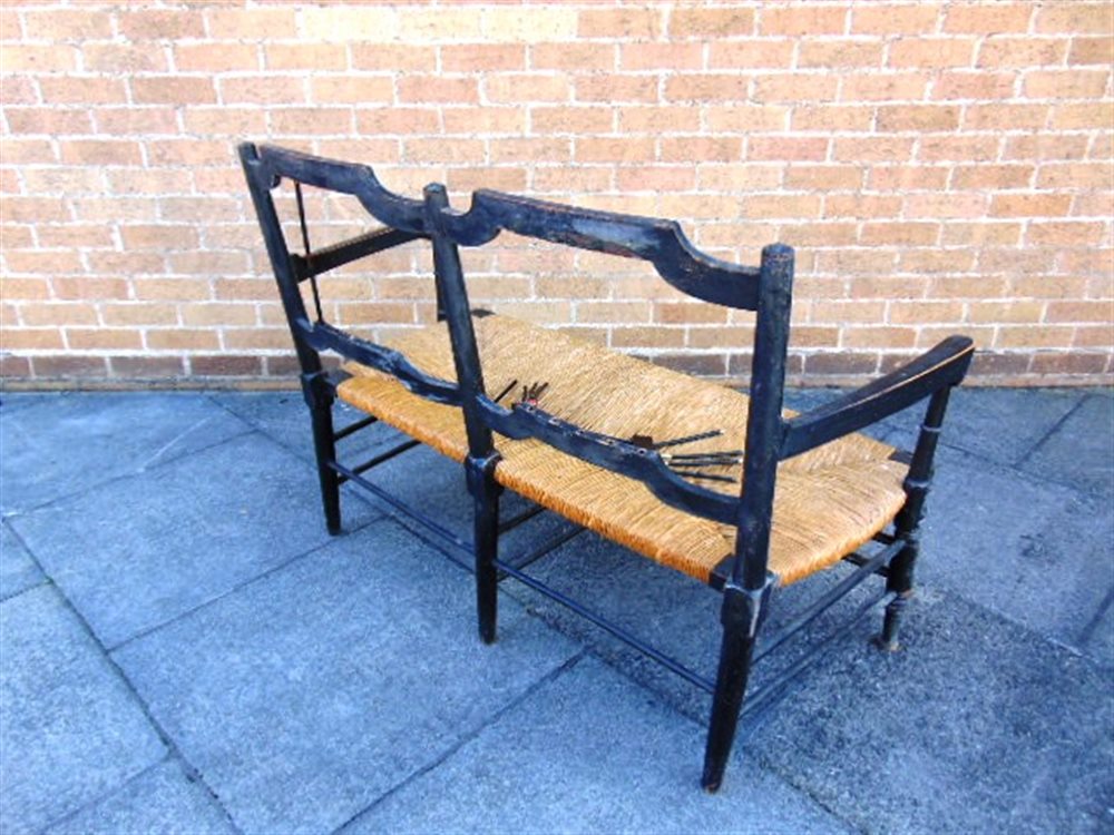 A WILLIAM MORRIS 'ROSETTI' RUSH SEAT SOFA, with ebonised beech frame on turned stretcher base, 119cm - Image 3 of 5