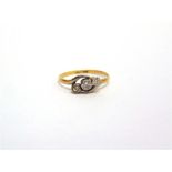 A THREE STONE RING stamped '18ct' and 'Plat', set with two diamonds and one plate, finger size O,