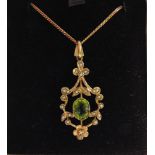 A 9 CARAT GOLD PERIDOT AND SEED PEARL PENDANT in the Edwardian style, 3.5cm long excluding the bale,