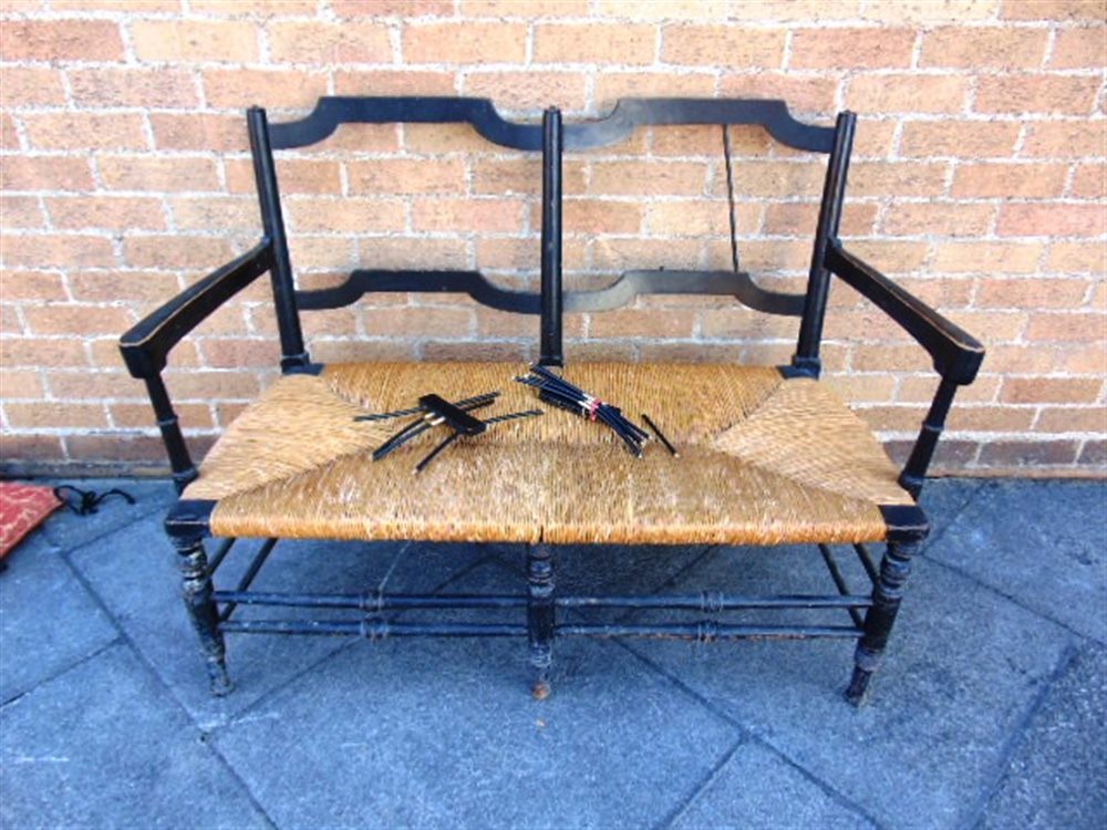 A WILLIAM MORRIS 'ROSETTI' RUSH SEAT SOFA, with ebonised beech frame on turned stretcher base, 119cm