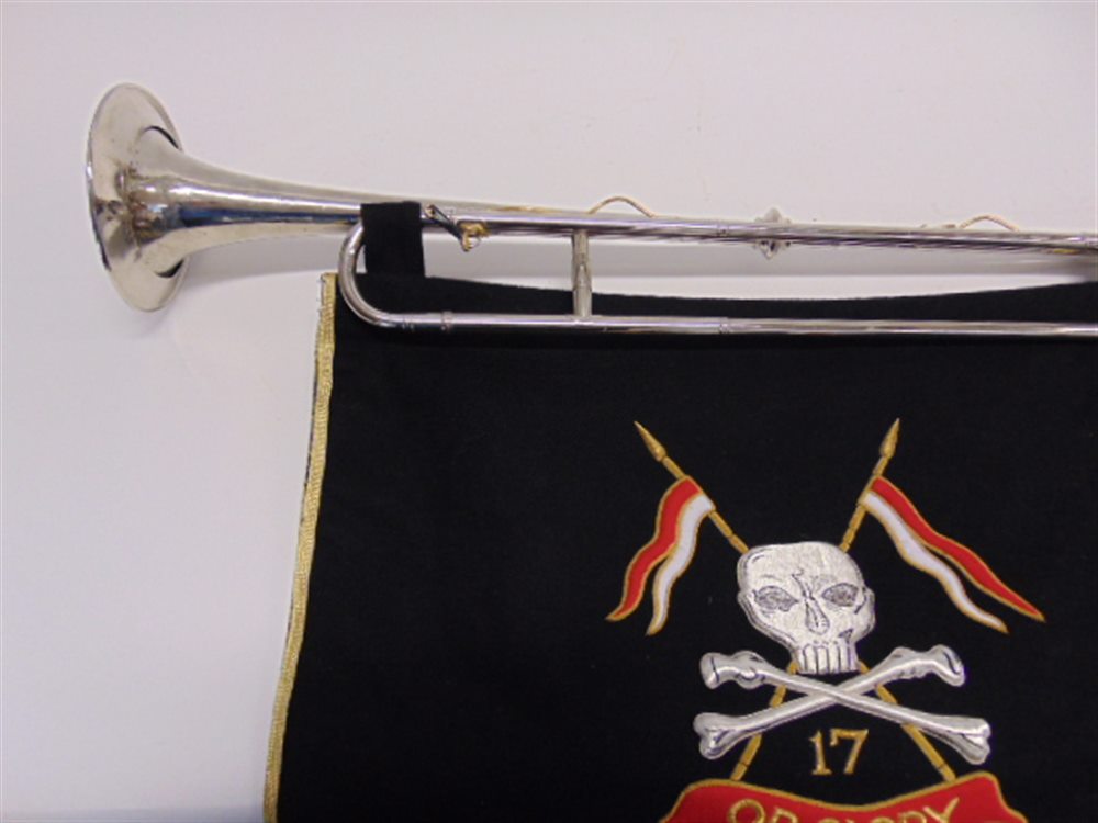 A SILVER PLATED MILITARY TRUMPET 76cm long (lacking mouth-piece), with a suspended embroidered - Image 2 of 2