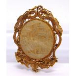 A CHINESE MOTHER OF PEARL MOUNTED PENDANT the oval panel within an unmarked gold coloured filigree