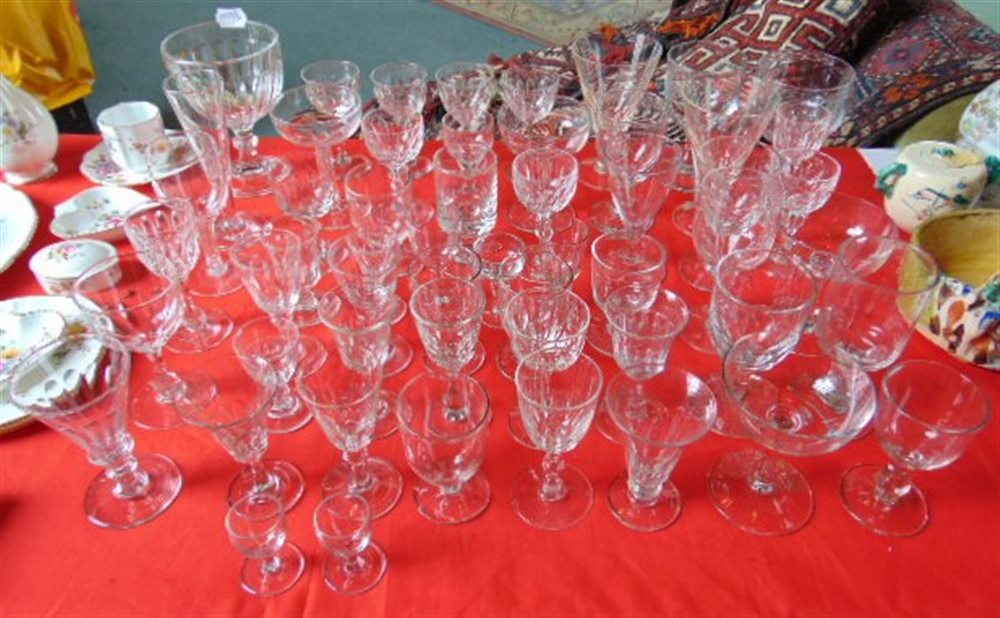 A COLLECTION OF APPROXIMATELY 55 DRINKING GLASSES including champagne glasses (two with facet cut