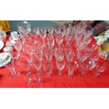 A COLLECTION OF APPROXIMATELY 55 DRINKING GLASSES including champagne glasses (two with facet cut