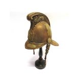 A FIRE OFFICER'S PLATED NICKEL HELMET early 20th century, with torch and crossed axes badge and