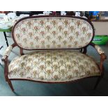 A FRENCH CARVED BEECH FRAMED UPHOLSTERED SOFA with serpentine front seat on turned and fluted