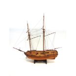 A MODEL OF THE BRITISH SCHOONER 'H.M.S. SULTANA' of wooden construction, rigged without sail, on a