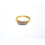 A THREE STONE DIAMOND 18 CARAT GOLD RING the uniform brilliant cuts totalling approximately 0.36