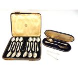 A CASED SET OF A DOZEN SILVER TEASPOONS with tongs; a cased silver fork and spoon set; and a