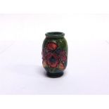 A MOORCROFT MINIATURE VASE with tubelined orchid decoration, 54mm high, possibly a tradesmans