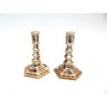 A PAIR OF 'AUGUSTUS REX' HEXAGONAL CANDLESTICKS with polychrome enamelled decoration of courting