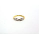 A SEVEN STONE DIAMOND 18 CARAT GOLD HALF HOOP RING the brilliant cuts totalling approximately 0.35