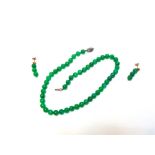 A UNIFORM ROW OF JADE BEADS the fifty beads of approximately 8.3mm diameter, to a silver coloured