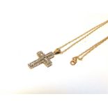 A 9 CARAT GOLD DIAMOND SET CROSS with forty nine single cuts and twenty nine tapering baguette cuts,