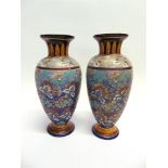 A PAIR OF DOULTON SALTGLAZE STONEWARE VASES of baluster form with pedestal bases and flared rims,