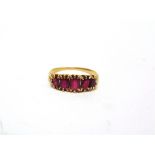 A LATE VICTORIAN FINE STONE RUBY RING with graduated oval cuts, finger size L 1/2, 2.5g gross.