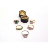 A 9 CARAT GOLD SEVEN STONE EMERALD HALF HOOP RING 2g gross; a single stone silver ring; an