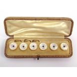 A CASED SET OF SIX MOTHER OF PEARL AND SAPPHIRE DRESS BUTTONS stamped '18', circa 1920, 1.4cm