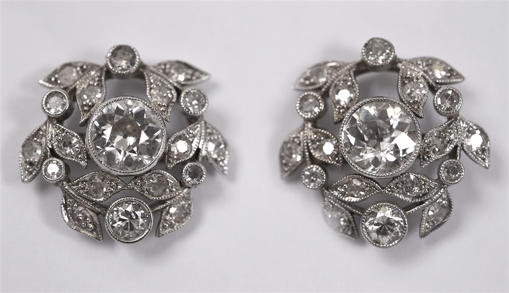 A PAIR OF DIAMOND CLUSTER EARSTUDS the central stone of approximately 0.5 carats enclosed by a