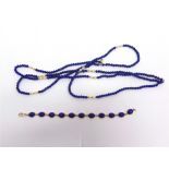 A 9 CARAT GOLD LAPIS LAZULI BRACELET composed of eleven cabochons, 18cm long, 9.6g gross; with a