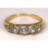 A LATE VICTORIAN FIVE STONE DIAMOND RING the graduated old brilliant cuts totalling approximately