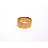 A 9 CARAT GOLD RING decorated with a cross and two doves of peace, inscribed to the inside is the